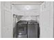 Well-lit laundry room, washer, dryer, and ample shelving at 8229 Eagles Park N Dr, St Petersburg, FL 33709