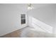 Minimalist bedroom with tiled floor, ceiling fan, and a window letting in natural light at 8419 Quarter Horse Dr, Riverview, FL 33578