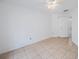 Clean bedroom featuring a ceiling fan and neutral-colored tile flooring at 8419 Quarter Horse Dr, Riverview, FL 33578