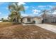 Single-story house with a garage, driveway, and landscaping at 8419 Quarter Horse Dr, Riverview, FL 33578