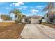 Front view of a single story house with a garage and a yard at 8419 Quarter Horse Dr, Riverview, FL 33578