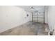 Empty single-car garage ready for parking or storage with concrete floors at 8419 Quarter Horse Dr, Riverview, FL 33578