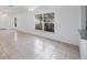 Bright living room featuring tile floors, ceiling fan, and ample natural light from large windows at 8419 Quarter Horse Dr, Riverview, FL 33578