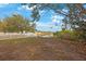 Waterfront lot with white vinyl fence and mature trees at 8419 Quarter Horse Dr, Riverview, FL 33578