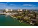 Aerial showcasing a waterfront home with private dock and neighboring buildings at 9320 Gulf Blvd, St Pete Beach, FL 33706