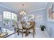 Elegant dining room with chandelier and large windows at 10919 Australian Pine Dr, Riverview, FL 33579