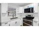 White cabinets, stainless steel appliances, and sink at 11119 N 21St St, Tampa, FL 33612