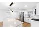 Modern white kitchen with stainless steel appliances and island at 11119 N 21St St, Tampa, FL 33612