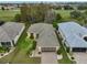 Aerial view of single-story house with golf course views and a spacious yard at 1123 Emerald Dunes Dr, Sun City Center, FL 33573