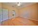 Hardwood floor bedroom with ceiling fan and access to bathroom at 1123 Emerald Dunes Dr, Sun City Center, FL 33573