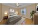 Spacious bedroom with hardwood floors and neutral decor at 1123 Emerald Dunes Dr, Sun City Center, FL 33573