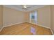 Bright bedroom with hardwood floors and neutral walls at 1123 Emerald Dunes Dr, Sun City Center, FL 33573