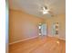 Spacious bedroom with hardwood floors and ceiling fan at 1123 Emerald Dunes Dr, Sun City Center, FL 33573