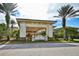 Club Renaissance community entrance with palm trees and a paved driveway at 1123 Emerald Dunes Dr, Sun City Center, FL 33573