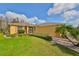 House exterior showcasing the side yard landscaping and a paved walkway at 1123 Emerald Dunes Dr, Sun City Center, FL 33573