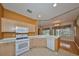 Bright kitchen with white appliances and light wood cabinets at 1123 Emerald Dunes Dr, Sun City Center, FL 33573