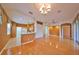 Kitchen with light wood cabinets, white appliances, and a breakfast bar at 1123 Emerald Dunes Dr, Sun City Center, FL 33573