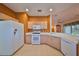 Bright kitchen with white appliances and light wood cabinets at 1123 Emerald Dunes Dr, Sun City Center, FL 33573