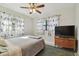 Cozy bedroom with a double bed, TV, and bird-themed curtains at 11388 77Th Ave, Seminole, FL 33772