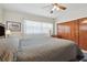 Primary bedroom with king bed, ceiling fan, and wood closet doors at 11388 77Th Ave, Seminole, FL 33772