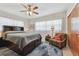 Spacious bedroom with a king-size bed and a comfortable armchair at 11388 77Th Ave, Seminole, FL 33772