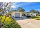 Mid-century modern home with a spacious driveway and landscaping at 11388 77Th Ave, Seminole, FL 33772