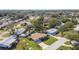 Aerial view of neighborhood with houses and lush trees at 11388 77Th Ave, Seminole, FL 33772