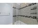 Modern bathroom featuring a shower over the tub, with stylish tile accents at 1209 E Cumberland Ave # 505, Tampa, FL 33602