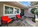 Relaxing front porch with comfortable seating and brick pavers at 12717 Carte Dr, Tampa, FL 33618