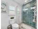 Modern bathroom with a walk-in shower and herringbone tile at 14042 Starboard Dr, Seminole, FL 33776