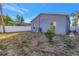 View of backyard, showing small tree, fence, and AC unit at 1410 Prescott S St, St Petersburg, FL 33712