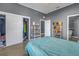 Spacious bedroom with double closet and teal bedding at 1410 Prescott S St, St Petersburg, FL 33712