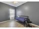 Bedroom with daybed and chair, gray walls, and window at 1410 Prescott S St, St Petersburg, FL 33712