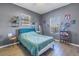 Bright bedroom with teal bedding, wood-look floors, and built-in shelving at 1410 Prescott S St, St Petersburg, FL 33712