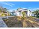 Gray house with white garage door and small front yard at 1410 Prescott S St, St Petersburg, FL 33712