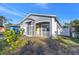 Newly renovated gray house with yellow door, white porch and a fenced yard at 1410 Prescott S St, St Petersburg, FL 33712