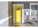 Bright yellow front door with sidelights, and two chairs on the porch at 1410 Prescott S St, St Petersburg, FL 33712