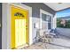 Inviting front porch with yellow door and seating at 1410 Prescott S St, St Petersburg, FL 33712