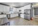 Modern kitchen with white cabinets, stainless steel appliances, and tile floors at 1410 Prescott S St, St Petersburg, FL 33712