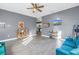 Living room with teal sectional sofa, wood floors, and view into kitchen at 1410 Prescott S St, St Petersburg, FL 33712