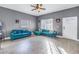 Living room with teal sectional sofa, wood floors, and ceiling fan at 1410 Prescott S St, St Petersburg, FL 33712