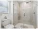 Bathroom with a walk-in shower, toilet, and window at 14341 Editors Note St, Ruskin, FL 33573