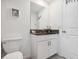 Small bathroom with granite countertop and white cabinets at 14341 Editors Note St, Ruskin, FL 33573