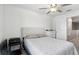 Bedroom with tufted headboard and ceiling fan at 14341 Editors Note St, Ruskin, FL 33573