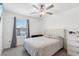 Bedroom with tufted headboard and ceiling fan at 14341 Editors Note St, Ruskin, FL 33573