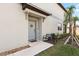 Inviting front entrance with a gray door and a small bench at 14341 Editors Note St, Ruskin, FL 33573