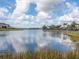 Scenic lakefront community with tranquil waters and lush landscaping at 14341 Editors Note St, Ruskin, FL 33573