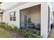 Screened porch with seating and landscaping at 14341 Editors Note St, Ruskin, FL 33573