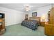 Spacious bedroom with a floral bedspread and wood furniture at 14525 Catalina Cir, Seminole, FL 33776