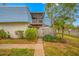 Back exterior view of condo, showing private patio and wooden fence at 14525 Catalina Cir, Seminole, FL 33776